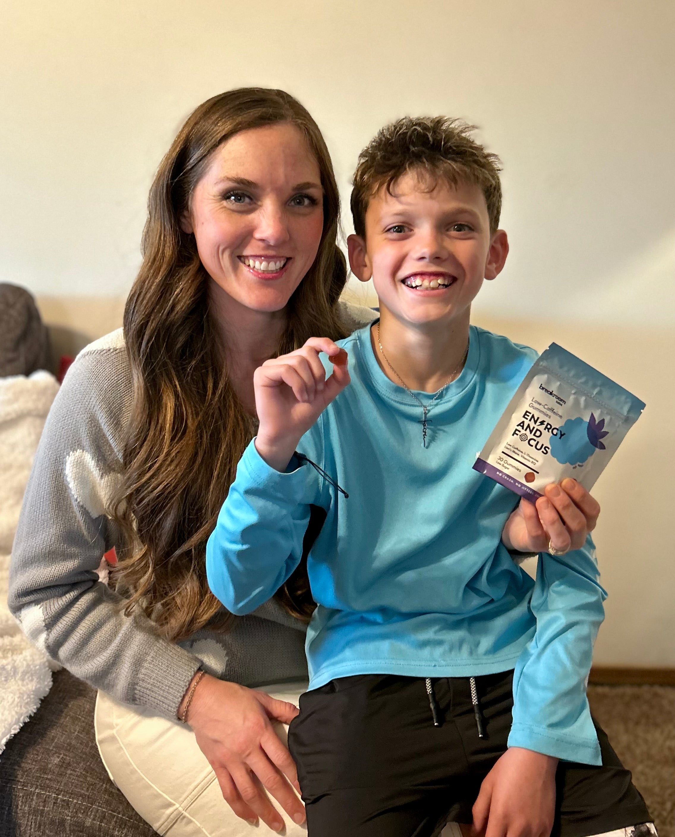 Mom and young boy holding a pack of Breakroom Labs Energy and Focus supplement